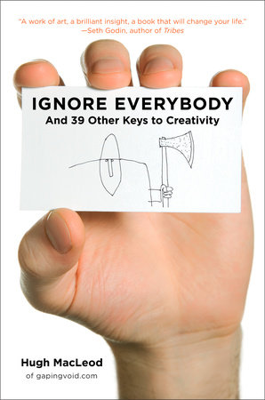 Ignore Everybody book cover shows a human hand holding a business card with the title of the book on the business card